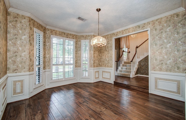 5810 Springton Ln, Spring, TX 77379 - unfurnished dining area featuring wallpapered walls, a chandelier, wainscoting, hardwood / wood-style flooring, and stairs