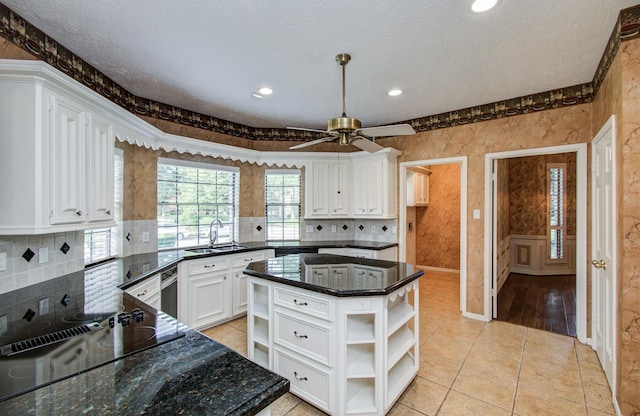 5810 Springton Ln, Spring, TX 77379 - kitchen featuring open shelves, a sink, white cabinets, black electric cooktop, and dark stone counters
