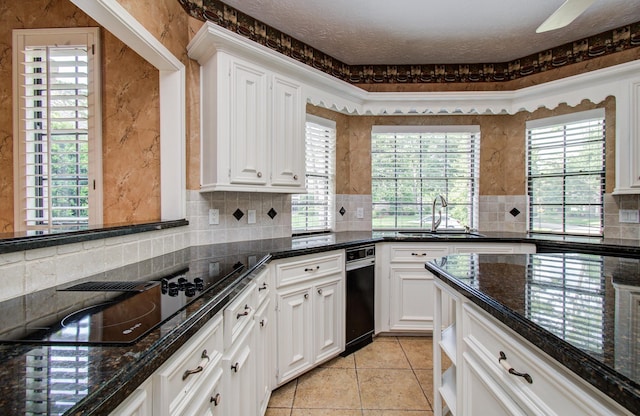 5810 Springton Ln, Spring, TX 77379 - kitchen featuring a sink, black electric stovetop, backsplash, and white cabinetry