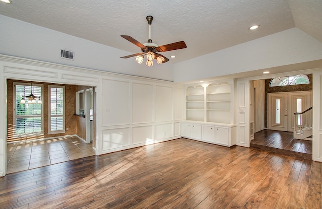 5810 Springton Ln, Spring, TX 77379 - unfurnished room featuring a decorative wall, hardwood / wood-style floors, ceiling fan, built in shelves, and a textured ceiling
