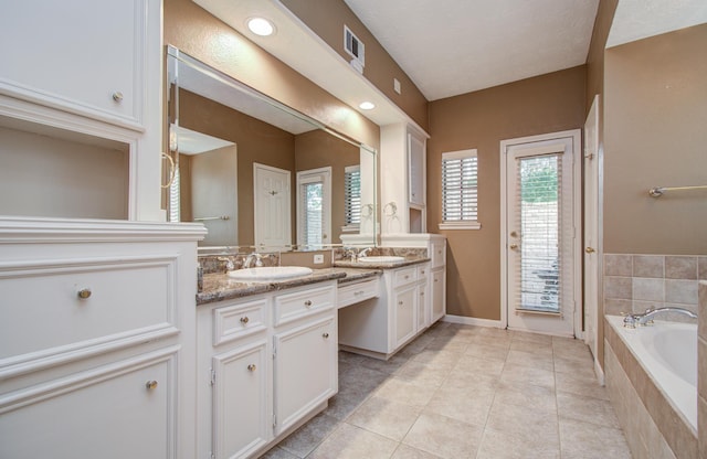 5810 Springton Ln, Spring, TX 77379 - full bath with vanity, a garden tub, tile patterned flooring, and baseboards