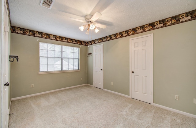 5810 Springton Ln, Spring, TX 77379 - unfurnished bedroom with carpet floors, a textured ceiling, baseboards, and ceiling fan