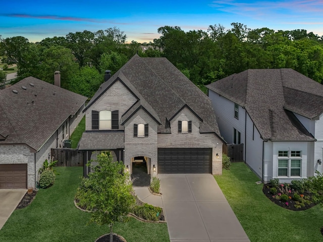 4818 Nodding Thistle Trl, Fulshear, TX 77441 - french provincial home with roof with shingles, driveway, a chimney, an attached garage, and brick siding