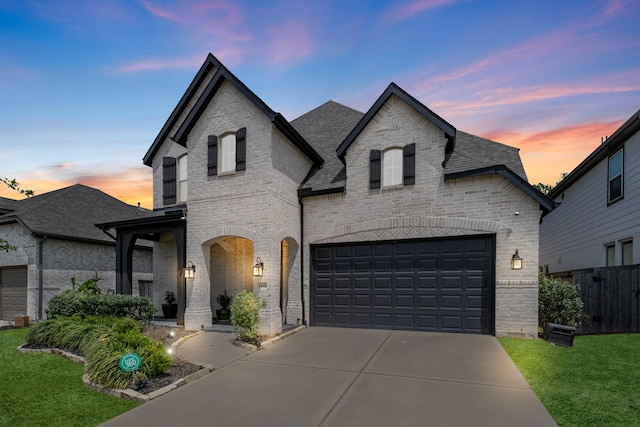 4818 Nodding Thistle Trl, Fulshear, TX 77441 - french country style house with brick siding, concrete driveway, and a shingled roof