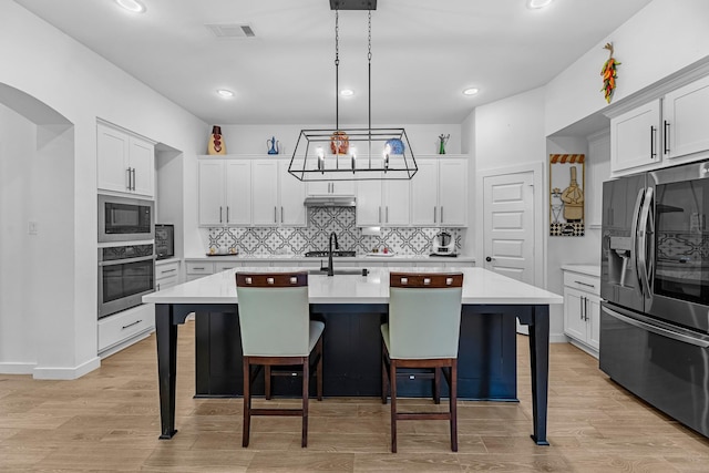 4818 Nodding Thistle Trl, Fulshear, TX 77441 - kitchen with refrigerator with ice dispenser, oven, built in microwave, light countertops, and backsplash