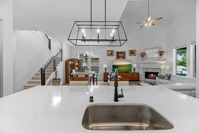 4818 Nodding Thistle Trl, Fulshear, TX 77441 - kitchen with a sink, open floor plan, plenty of natural light, a tiled fireplace, and a high ceiling