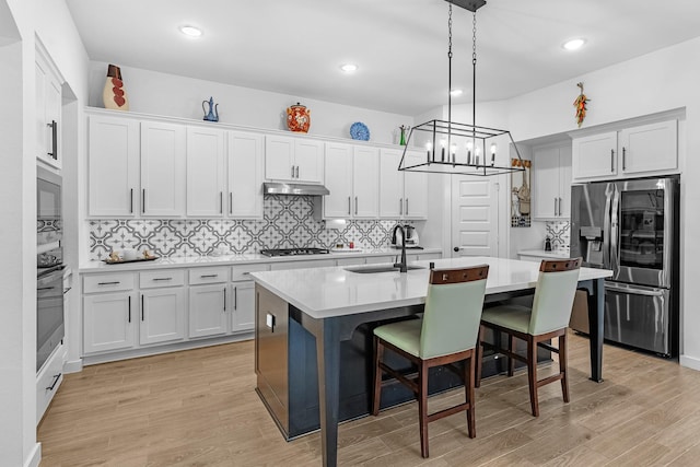 4818 Nodding Thistle Trl, Fulshear, TX 77441 - kitchen with stainless steel appliances, a sink, light countertops, a kitchen island with sink, and recessed lighting