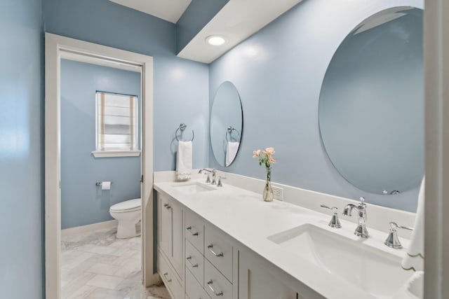 8019 Skyline Dr, Houston, TX 77063 - full bath featuring toilet, double vanity, marble look tiles, and baseboards