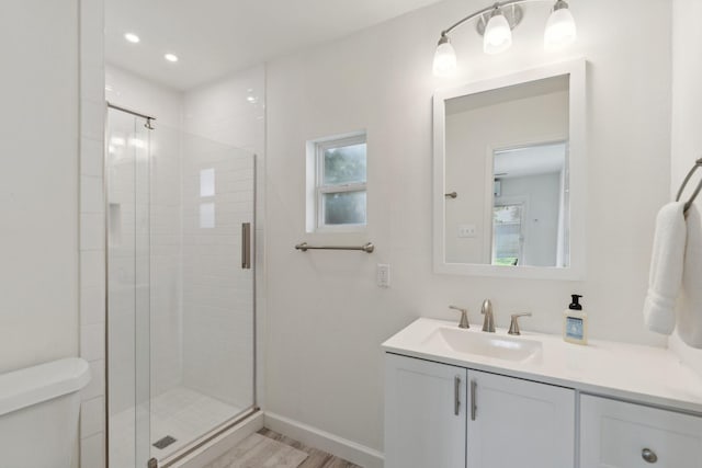 8019 Skyline Dr, Houston, TX 77063 - bathroom featuring toilet, vanity, a shower stall, wood finished floors, and baseboards