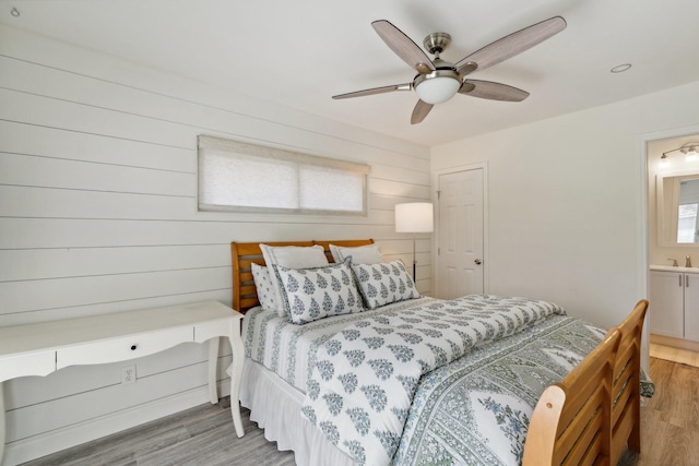 8019 Skyline Dr, Houston, TX 77063 - bedroom featuring light wood finished floors, a ceiling fan, a sink, and ensuite bath