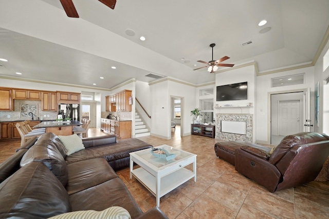 898 Mr G, Crystal Beach, TX 77650 - living area featuring ceiling fan, crown molding, a fireplace, recessed lighting, and stairs