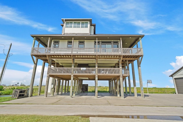 898 Mr G, Crystal Beach, TX 77650 - back of property with a carport, stairway, concrete driveway, and a porch