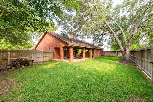 330 N 4th St, Beasley, TX 77417 - fenced backyard featuring a patio area