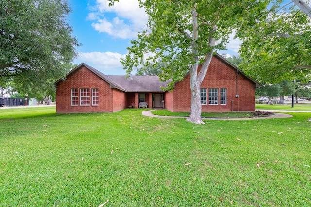 330 N 4th St, Beasley, TX 77417 - view of front of house featuring brick siding and a front lawn