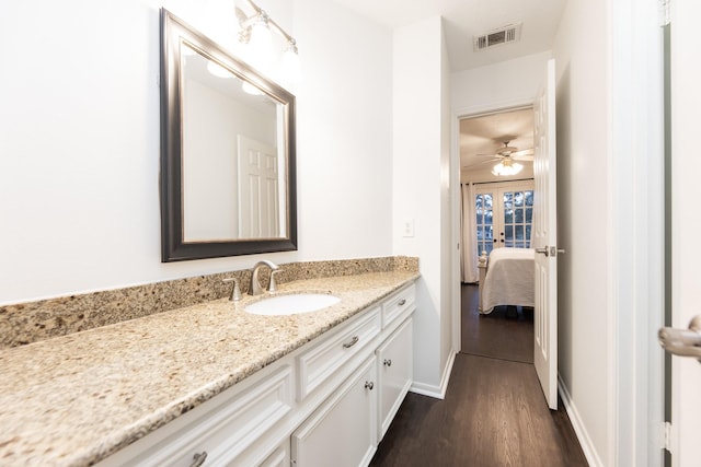 14102 N Suddley Castle St, Houston, TX 77095 - bathroom featuring vanity, wood finished floors, connected bathroom, baseboards, and ceiling fan
