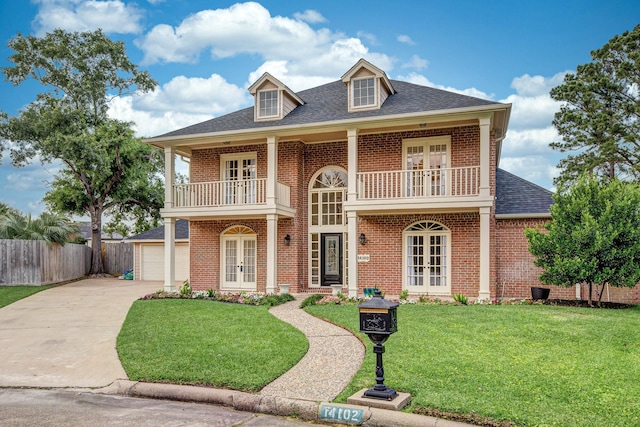 14102 N Suddley Castle St, Houston, TX 77095 - view of front facade with french doors, a balcony, brick siding, roof with shingles, and driveway