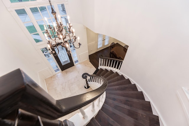 14102 N Suddley Castle St, Houston, TX 77095 - staircase featuring a chandelier, a towering ceiling, and baseboards