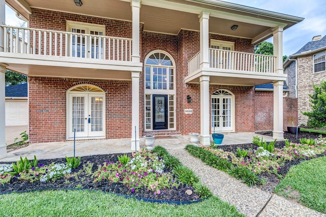14102 N Suddley Castle St, Houston, TX 77095 - doorway to property featuring french doors, a balcony, and brick siding