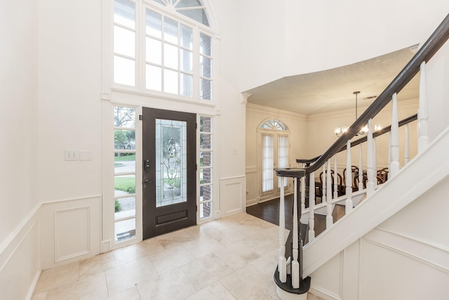 14102 N Suddley Castle St, Houston, TX 77095 - tiled foyer featuring a decorative wall, stairway, wainscoting, and a towering ceiling