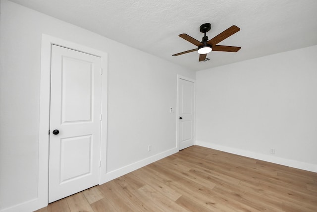 501 Schilling St, Baytown, TX 77520 - empty room featuring a ceiling fan, light wood-style floors, baseboards, and a textured ceiling