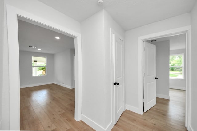 501 Schilling St, Baytown, TX 77520 - hallway with light wood-type flooring, healthy amount of natural light, recessed lighting, and baseboards