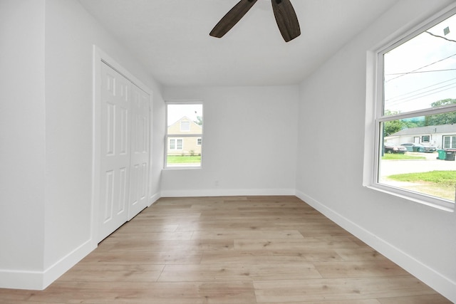 501 Schilling St, Baytown, TX 77520 - unfurnished bedroom with light wood-style floors, baseboards, a closet, and ceiling fan