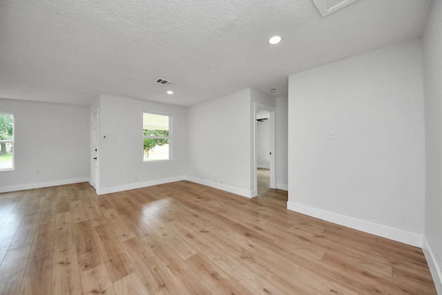 501 Schilling St, Baytown, TX 77520 - unfurnished room featuring light wood finished floors, a textured ceiling, baseboards, and recessed lighting