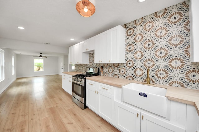 501 Schilling St, Baytown, TX 77520 - kitchen featuring gas stove, wooden counters, backsplash, open floor plan, and recessed lighting