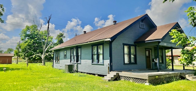 3137 18th St, Port Arthur, TX 77642 - back of house featuring a yard, central AC unit, a shingled roof, and a porch