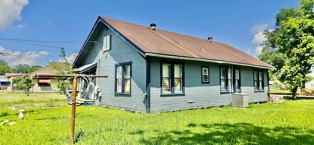 3137 18th St, Port Arthur, TX 77642 - back of house featuring a lawn and cooling unit