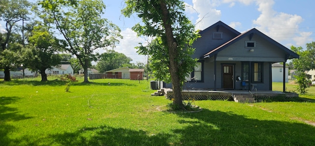 3137 18th St, Port Arthur, TX 77642 - view of grassy yard featuring a porch and central AC unit