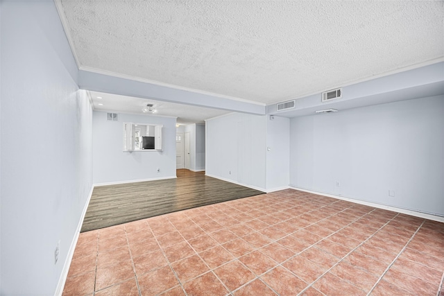 811 Lovett Blvd Unit 8, Houston, TX 77006 - unfurnished room featuring a textured ceiling, baseboards, tile patterned flooring, and ornamental molding