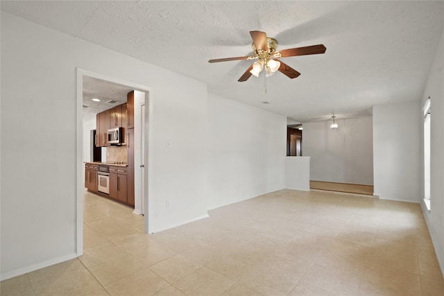 12839 Aste Ln, Houston, TX 77065 - unfurnished room featuring a ceiling fan, light tile patterned floors, a textured ceiling, and baseboards