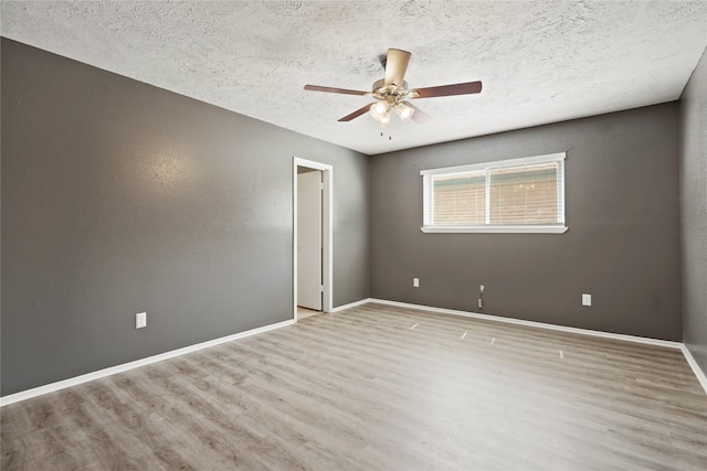 12839 Aste Ln, Houston, TX 77065 - empty room featuring wood finished floors, a ceiling fan, a textured ceiling, and baseboards