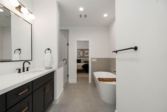 2522 Live Oak St, Houston, TX 77004 - ensuite bathroom with vanity, a freestanding tub, recessed lighting, tile patterned flooring, and a stall shower