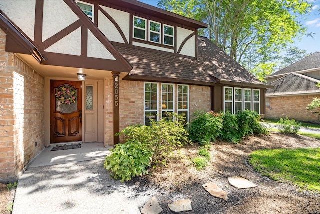 2055 Pine River Dr, Houston, TX 77339 - doorway to property with brick siding, a shingled roof, and stucco siding