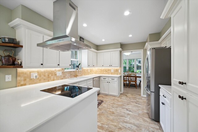 2055 Pine River Dr, Houston, TX 77339 - kitchen with island range hood, stainless steel appliances, a sink, backsplash, and white cabinets