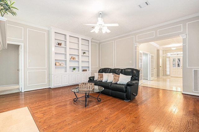 3506 Park Springs Ln, Houston, TX 77345 - living room with a decorative wall, ornate columns, wood finished floors, ceiling fan, and crown molding