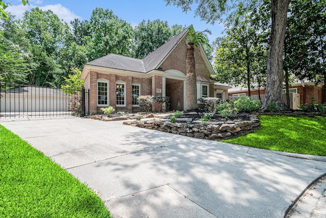 3506 Park Springs Ln, Houston, TX 77345 - view of front of property with a gate, brick siding, and concrete driveway