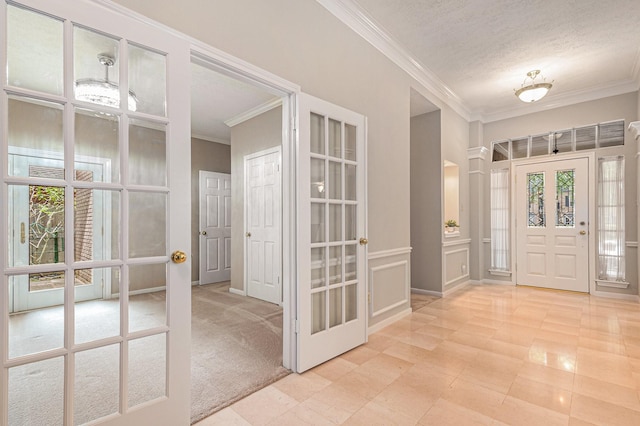 3506 Park Springs Ln, Houston, TX 77345 - foyer entrance with healthy amount of natural light, ornamental molding, french doors, and a textured ceiling