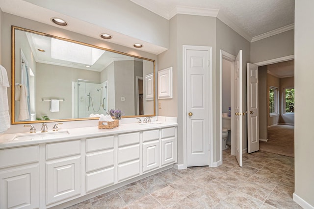 3506 Park Springs Ln, Houston, TX 77345 - bathroom featuring a skylight, double vanity, crown molding, a stall shower, and toilet