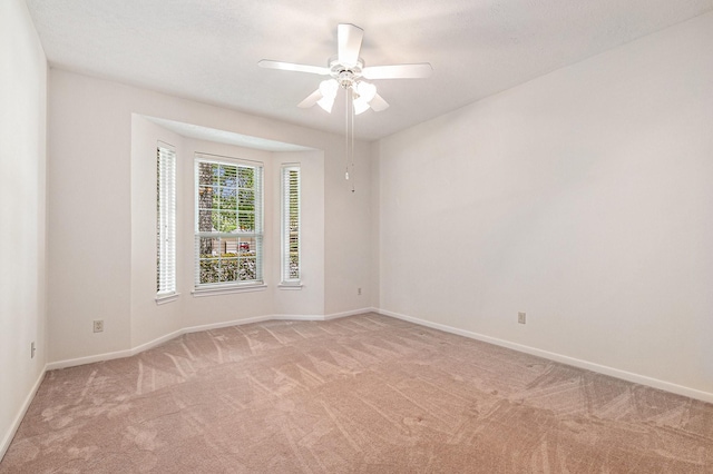 3506 Park Springs Ln, Houston, TX 77345 - empty room featuring light colored carpet, a ceiling fan, and baseboards