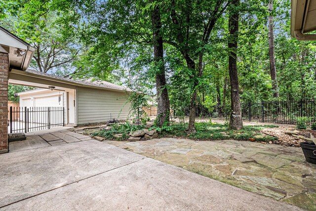 3506 Park Springs Ln, Houston, TX 77345 - view of patio featuring a garage and driveway