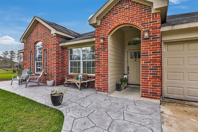 19715 Desna Dr, Porter, TX 77365 - property entrance featuring brick siding, an attached garage, driveway, and a shingled roof
