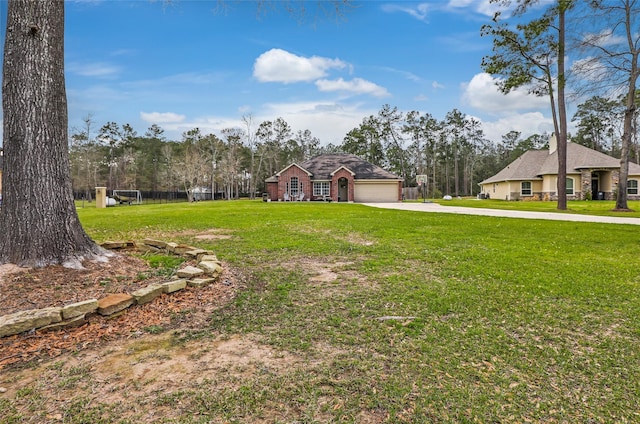 19715 Desna Dr, Porter, TX 77365 - view of grassy yard featuring concrete driveway and an attached garage
