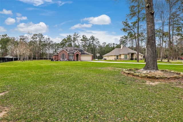 19715 Desna Dr, Porter, TX 77365 - view of green lawn with an attached garage, driveway, and view of wooded area