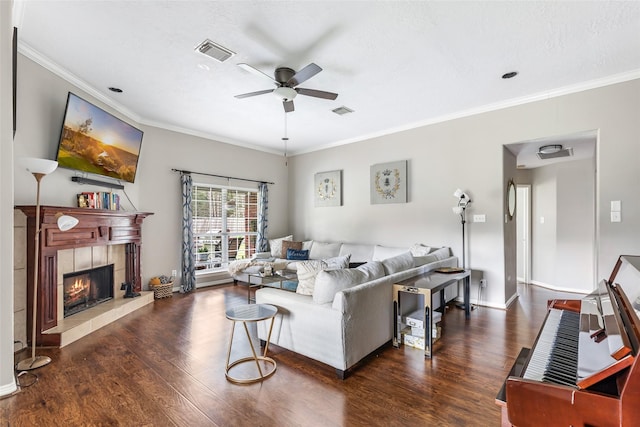 19715 Desna Dr, Porter, TX 77365 - living area featuring a ceiling fan, wood finished floors, crown molding, a tiled fireplace, and baseboards