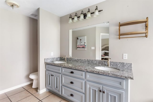19715 Desna Dr, Porter, TX 77365 - bathroom featuring tile patterned floors, double vanity, toilet, and baseboards