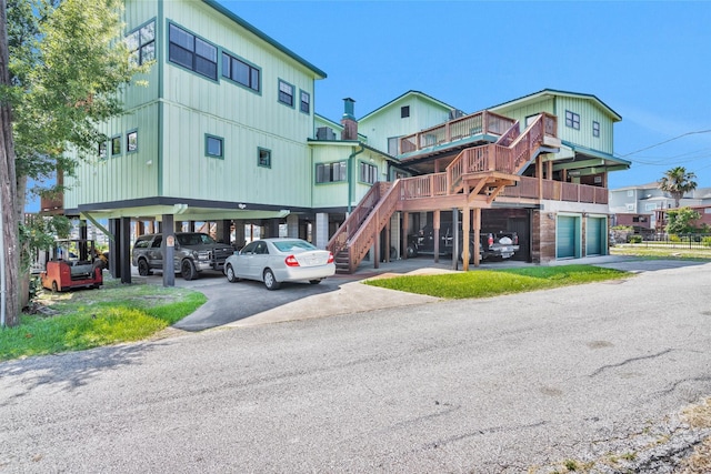 319 W Shore Dr, Kemah, TX 77565 - view of property with asphalt driveway, stairway, and a carport