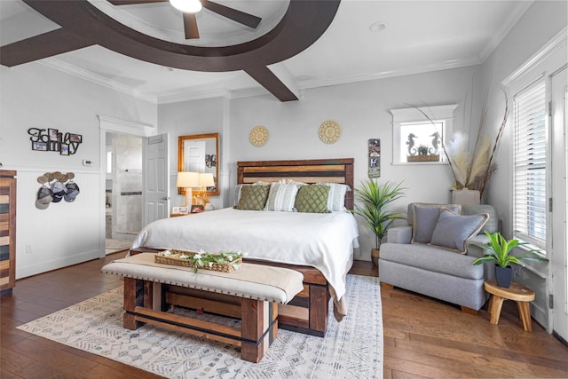 319 W Shore Dr, Kemah, TX 77565 - bedroom with wood-type flooring, crown molding, a wainscoted wall, connected bathroom, and ceiling fan